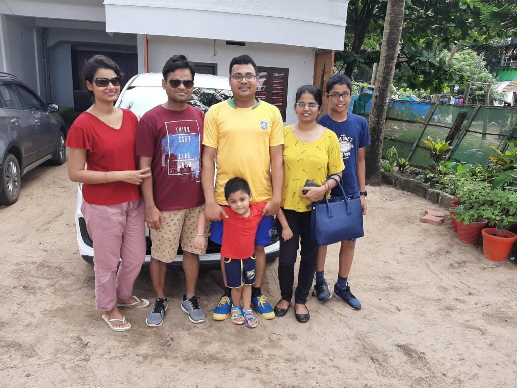 a group of people standing in front of a car at Cherai Ocean View Home in Cherai Beach
