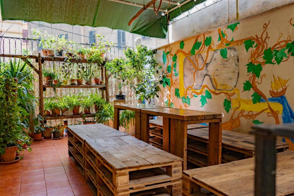 an outdoor area with a wooden table and chairs at A Casa di Amici in Palermo