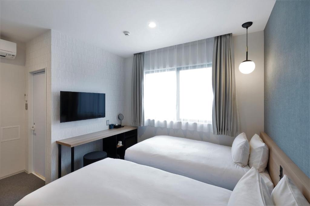 Postel nebo postele na pokoji v ubytování M's Hotel Sanjo Omiya