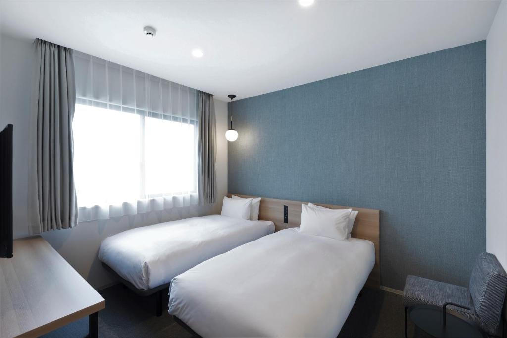 Postel nebo postele na pokoji v ubytování M's Hotel Sanjo Omiya