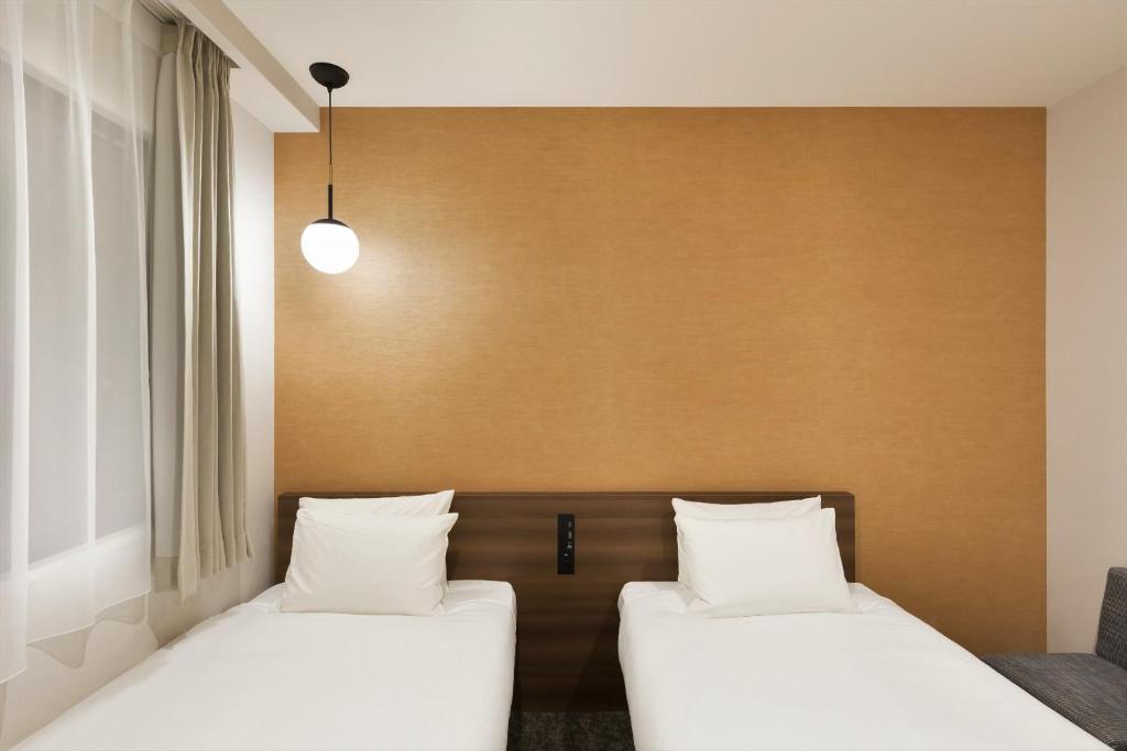 Postel nebo postele na pokoji v ubytování M's Hotel Sanjo Omiya