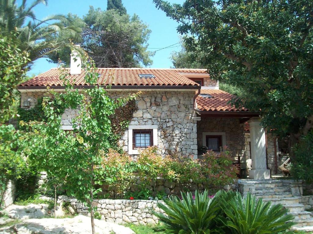 a stone house with a tile roof at STONE HOUSE reTREAT in Mali Lošinj