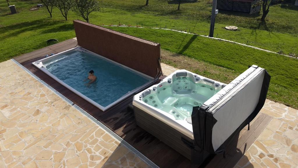 Un uomo in una piscina in un cortile di Svatá Panna a Loktuše