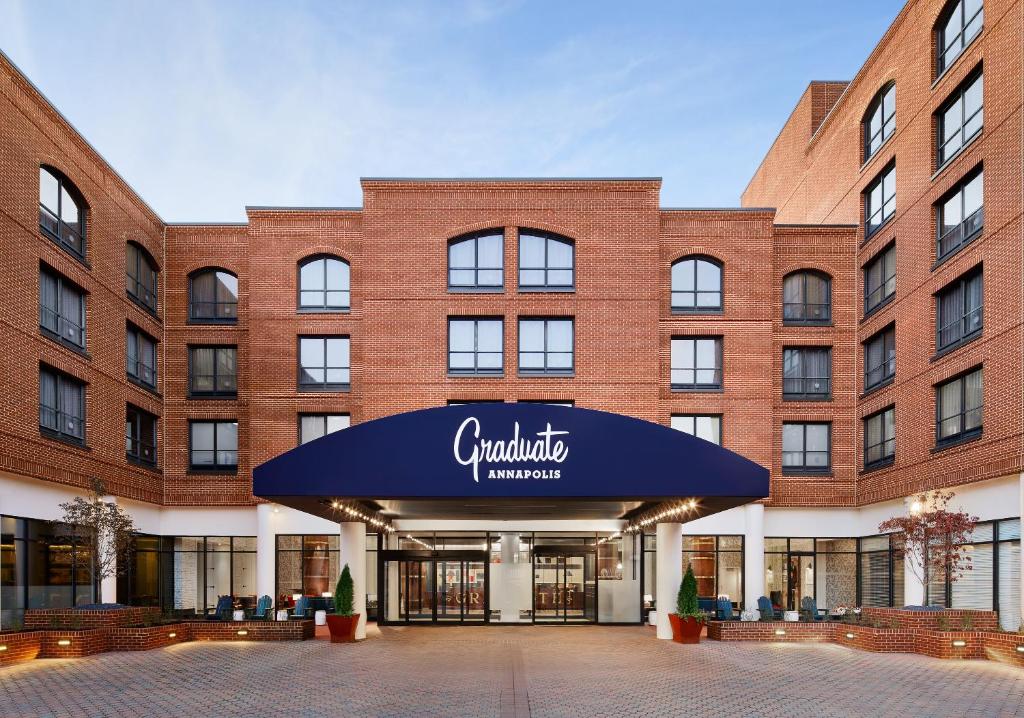 a large brick building with a blue awning at Graduate Annapolis in Annapolis