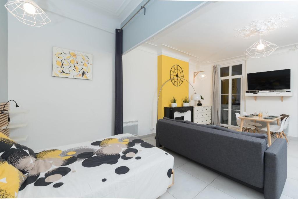 a bedroom with a bed and a couch at L'Olivaroise in Toulon