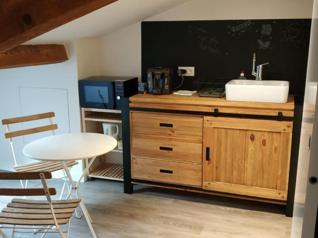 a kitchen with a sink and a counter with a table at Attic one bedroom flat in Old Town Lyon in Lyon