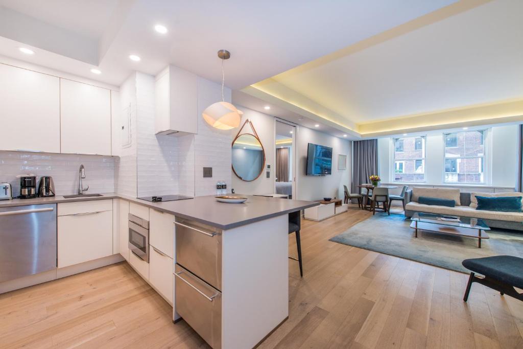 an open kitchen and living room with a couch at Lombardy Hotel in New York