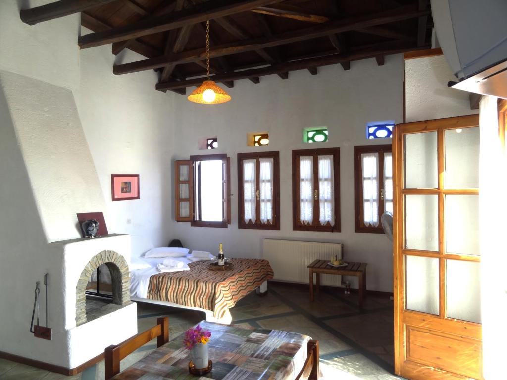 a room with a bed and a table in it at Villa Enallaxis in Agios Dimitrios