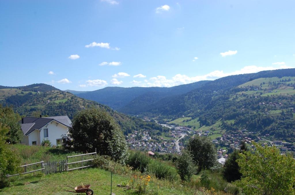 a view of a valley from a hill with a house at studio le panorama in La Bresse