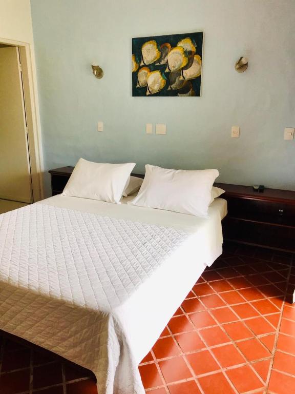 Cama ou camas em um quarto em Pousada Passeio Brig Maresias