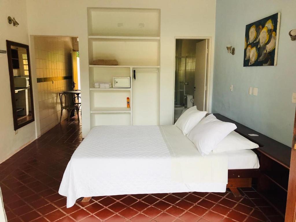 Cama ou camas em um quarto em Pousada Passeio Brig Maresias
