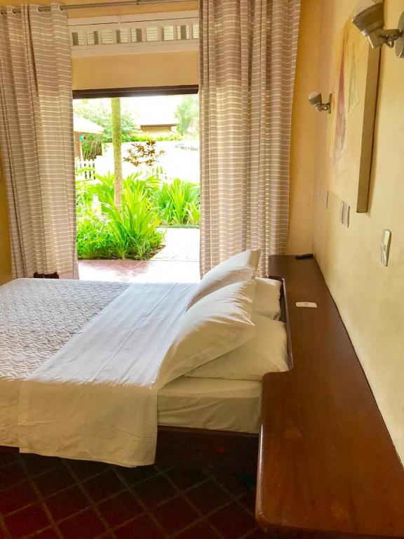 Cama ou camas em um quarto em Pousada Passeio Brig Maresias