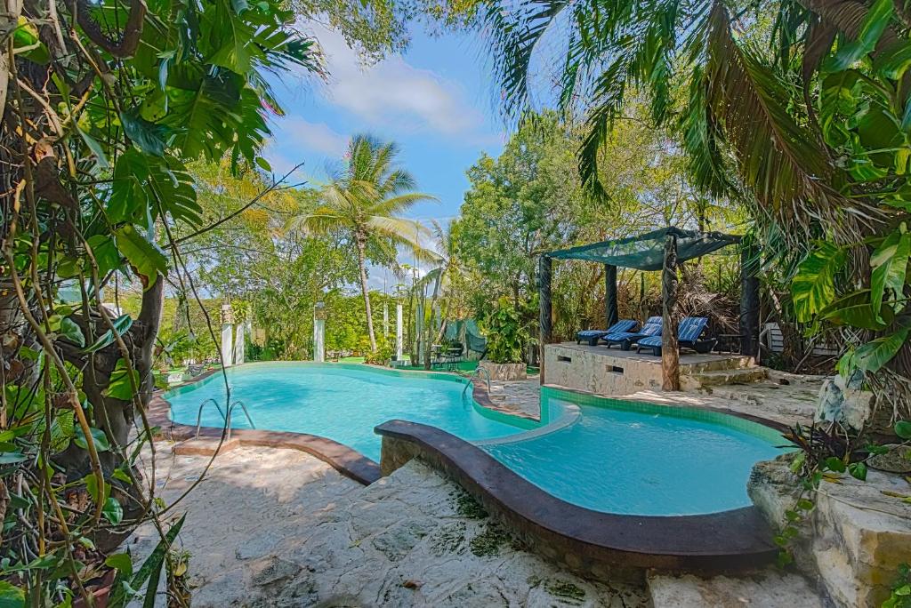 a swimming pool with a slide in a resort at Private Villa 10 Rooms, Private Pool, Walk to Beach in Playa del Carmen