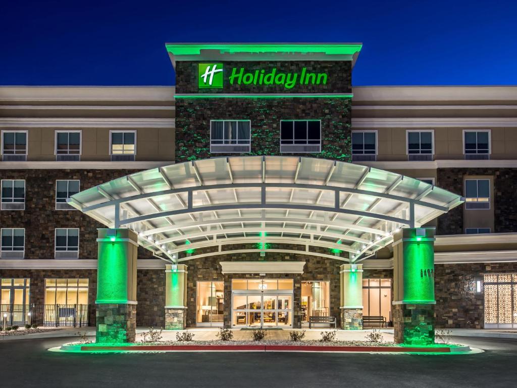 a hotel front of a building at night at Holiday Inn & Suites Houston NW - Willowbrook, an IHG Hotel in Houston