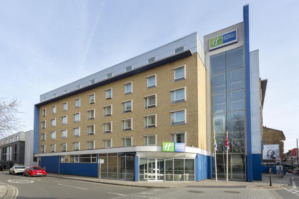 a large building on the corner of a street at Holiday Inn Express Earls Court, an IHG Hotel in London