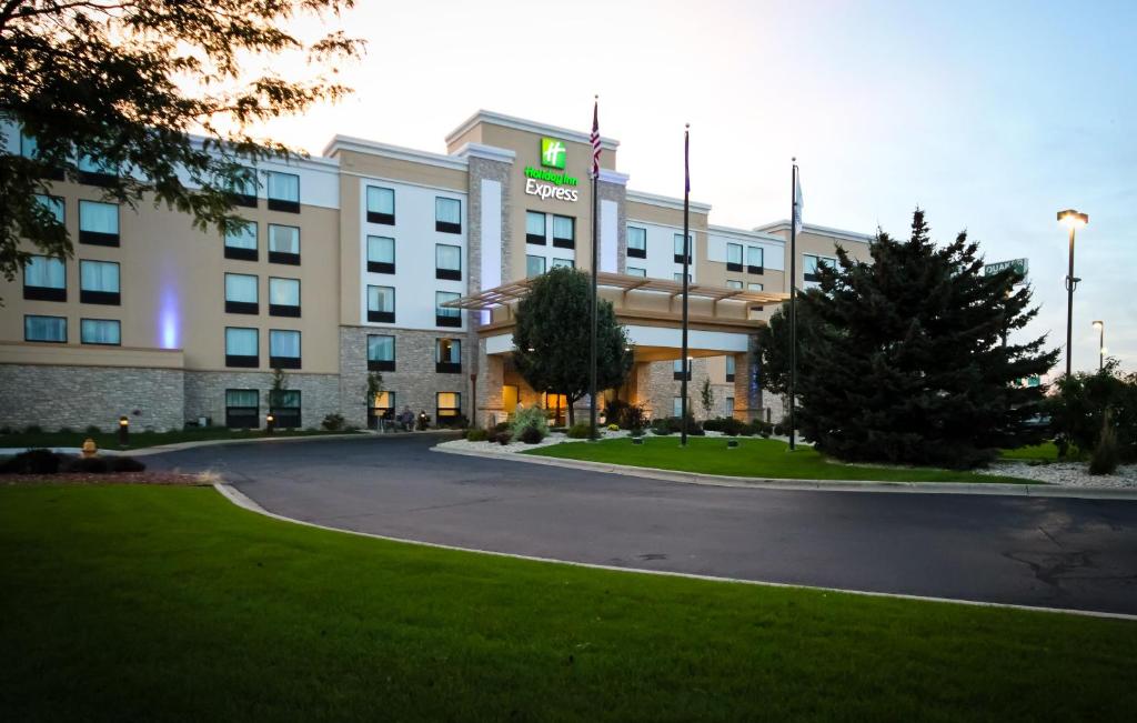 a hotel with a christmas tree in front of it at Holiday Inn Express Janesville-I-90 & US Highway 14, an IHG Hotel in Janesville