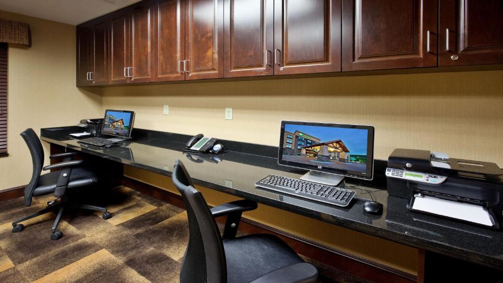 an office with a desk with a computer and two chairs at Holiday Inn Express and Suites Great Falls by IHG in Great Falls