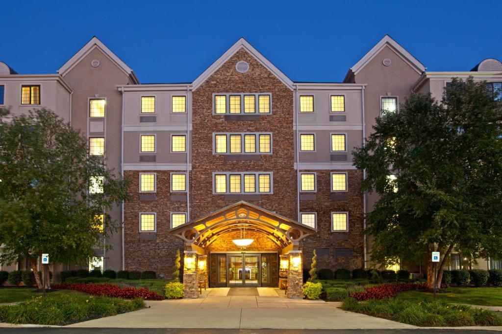 a large brick building with a pathway in front of it at Staybridge Suites Indianapolis-Fishers, an IHG Hotel in Fishers