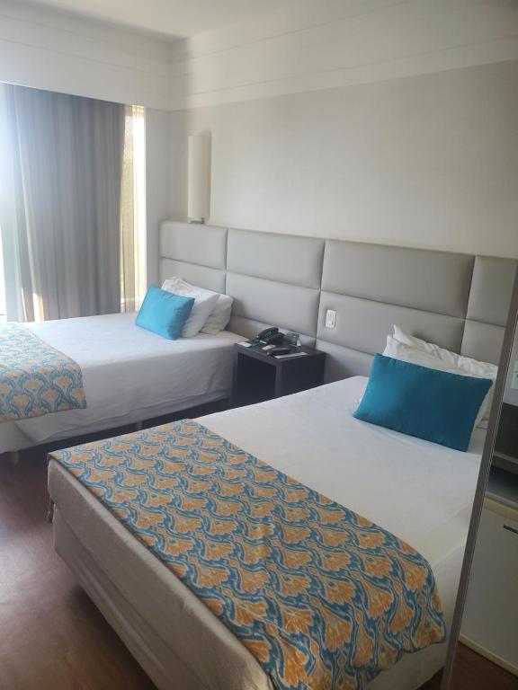 Giường trong phòng chung tại Flat Luxo Afonso Pena - Savassi/Serra/Mangabeiras