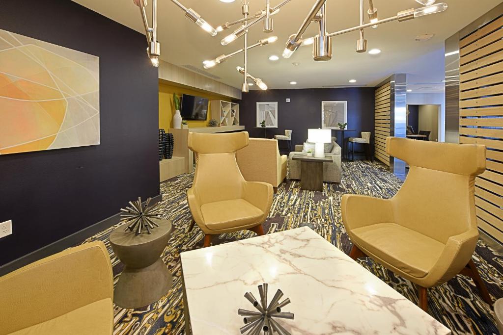 a waiting room at a dental office with chairs and a table at Staybridge Suites - Little Rock - Medical Center, an IHG Hotel in Little Rock