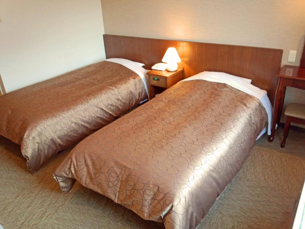 Postel nebo postele na pokoji v ubytování Hakuba Highland Hotel