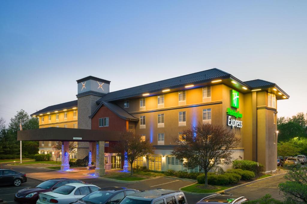 a hotel with cars parked in a parking lot at Holiday Inn Express Philadelphia NE - Langhorne, an IHG Hotel in Langhorne