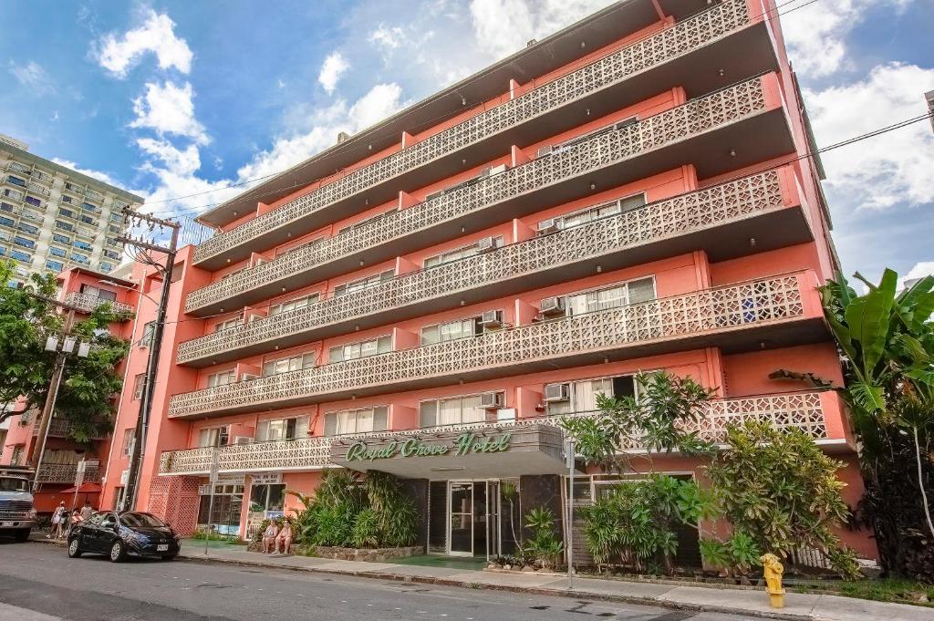 an orange building with balconies on a city street at Royal Grove Waikiki in Honolulu