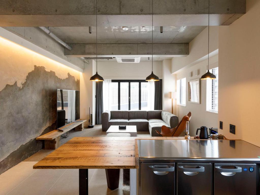 a kitchen and living room with a couch and a table at Hotel Mei Fukuoka Tenjin in Fukuoka