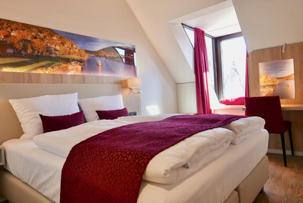 Postel nebo postele na pokoji v ubytování Rafaela Hotel Heidelberg