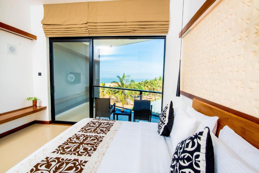 Postel nebo postele na pokoji v ubytování Goldi Sands Hotel