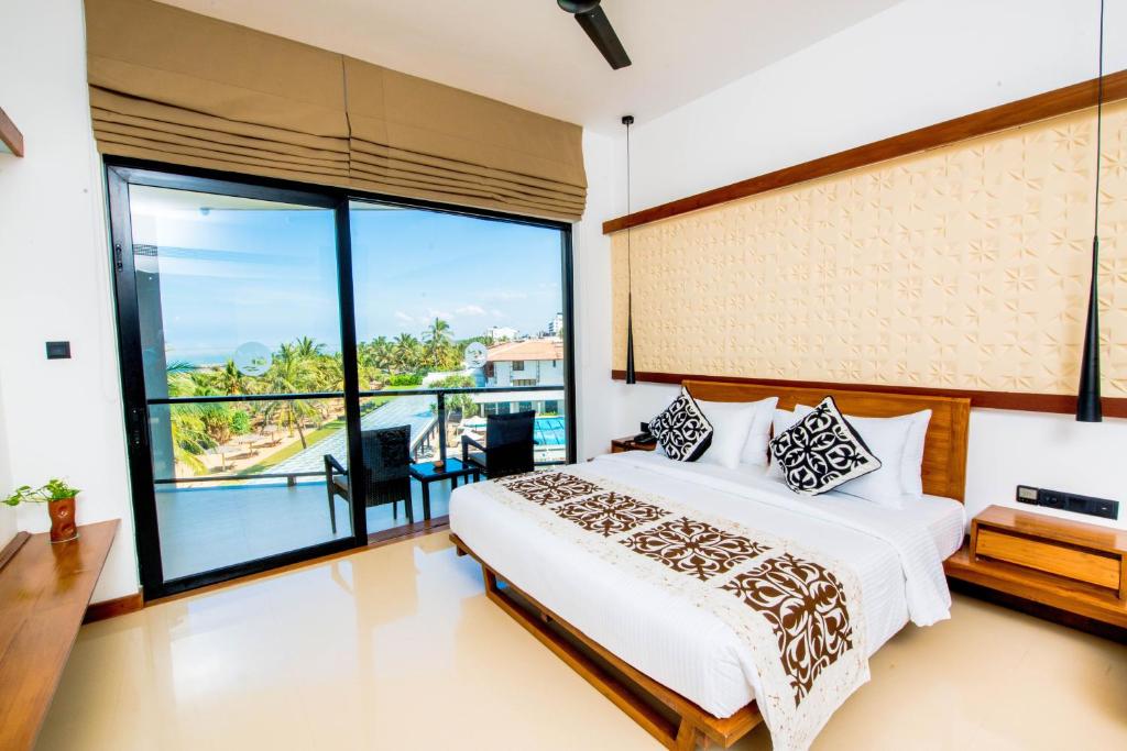 Postel nebo postele na pokoji v ubytování Goldi Sands Hotel