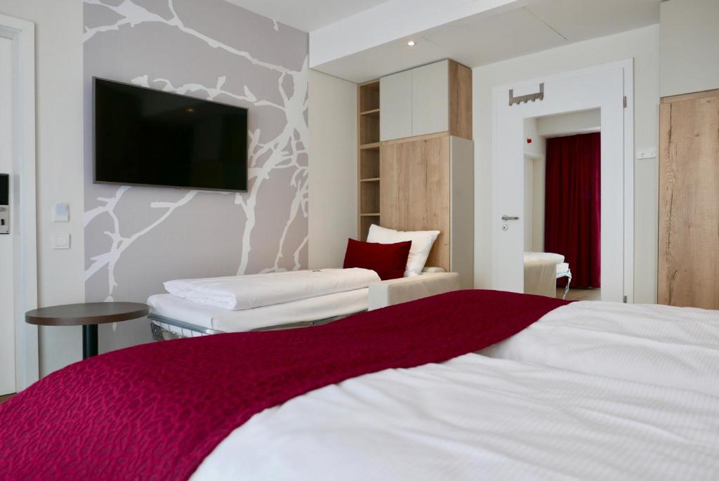 Postel nebo postele na pokoji v ubytování Rafaela Hotel Heidelberg