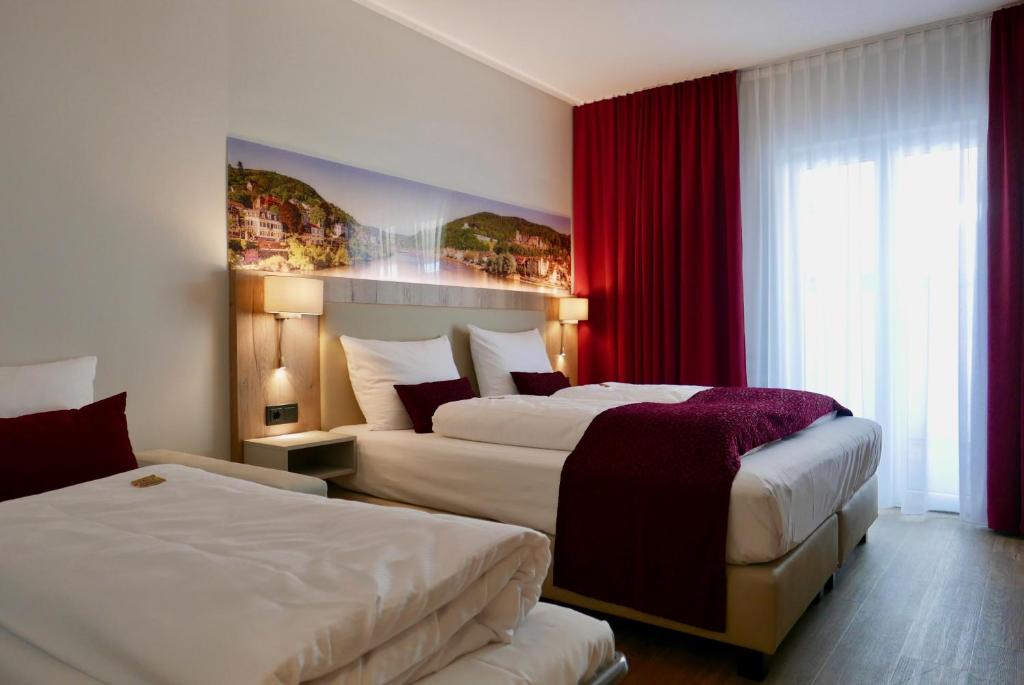 Postel nebo postele na pokoji v ubytování Rafaela Hotel Heidelberg