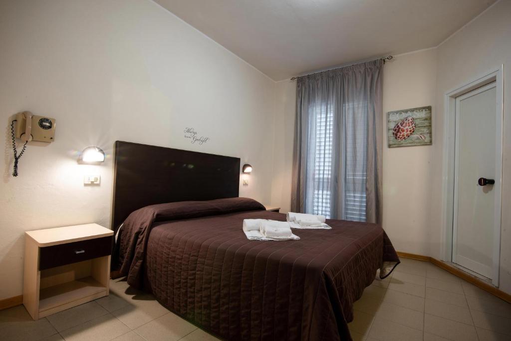 Postel nebo postele na pokoji v ubytování Hotel Vela D'Oro
