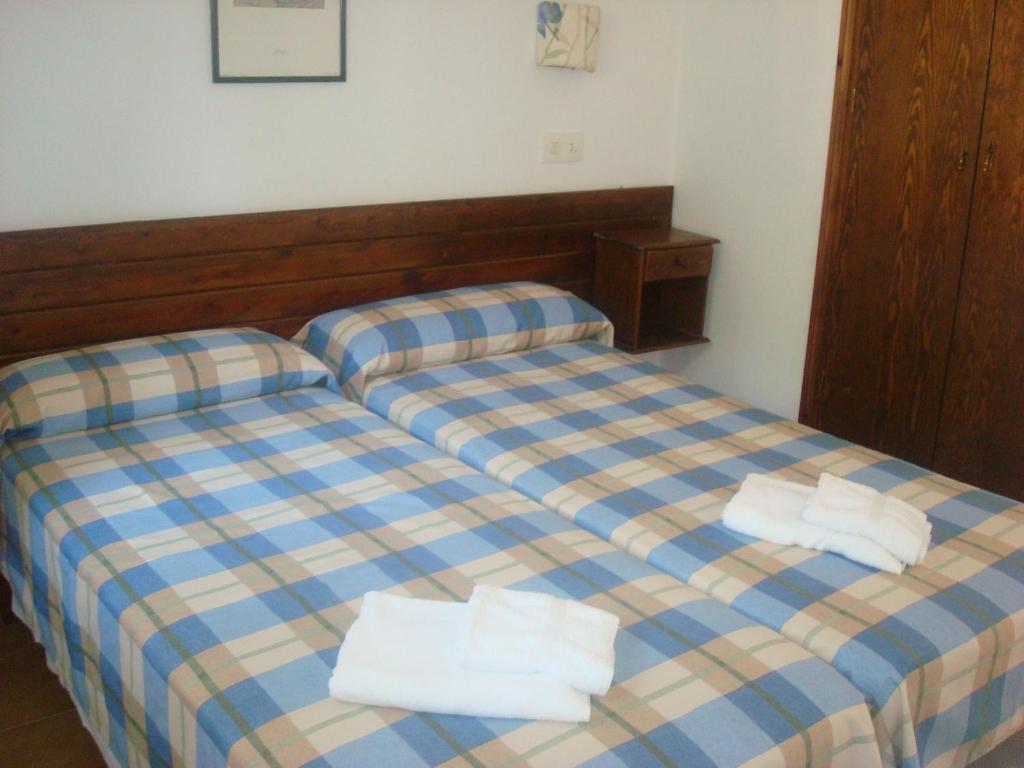 a bedroom with two beds with towels on them at Menorca Bonavista in Cala Galdana
