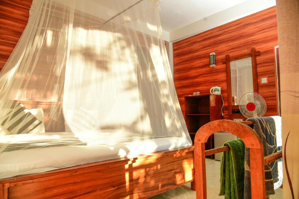 Postel nebo postele na pokoji v ubytování Senasuma Homestay