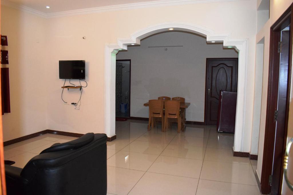 a living room with a couch and a table at White Tulip Residency in Puducherry