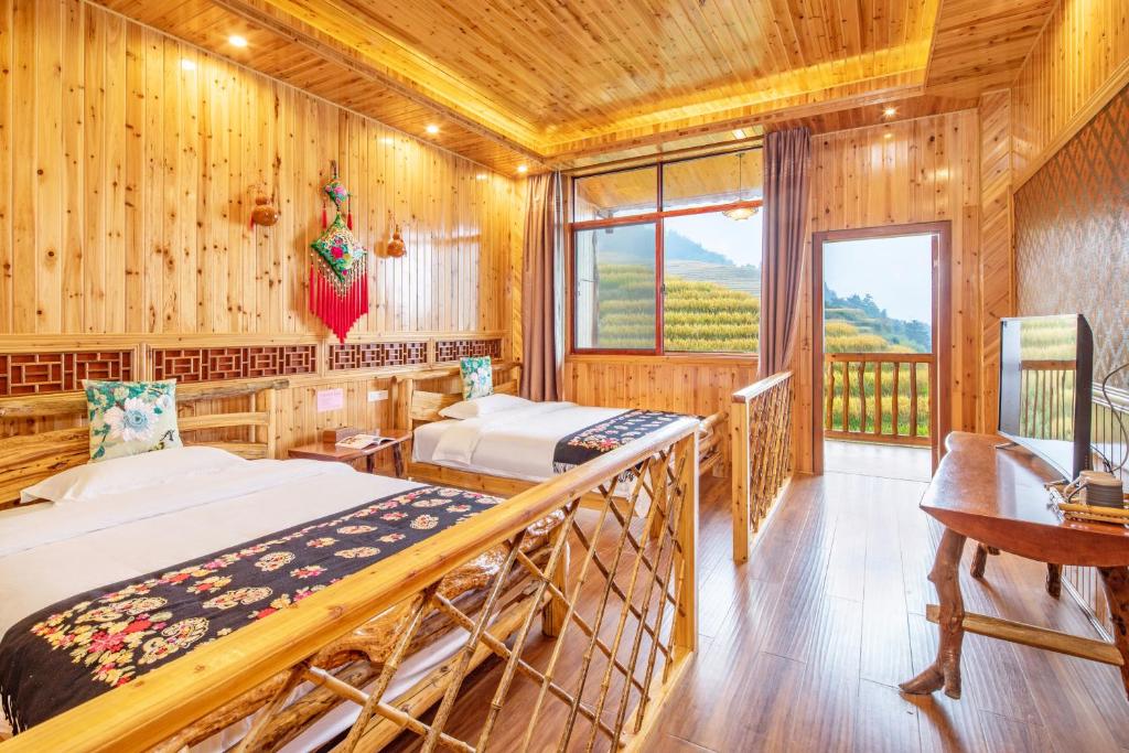 Postel nebo postele na pokoji v ubytování Long An Hotel 龙胜龙安酒店