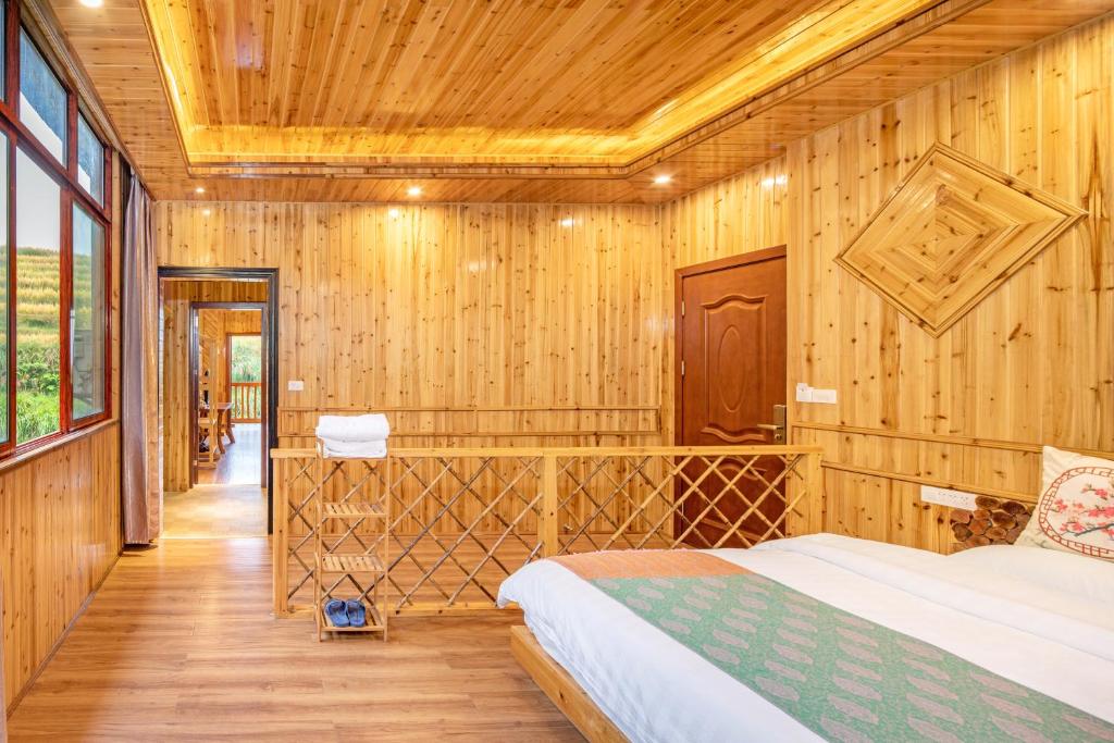 Postel nebo postele na pokoji v ubytování Long An Hotel 龙胜龙安酒店