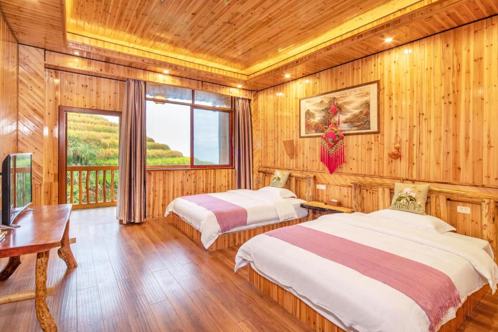 Postel nebo postele na pokoji v ubytování Long An Hotel 龙胜龙安酒店