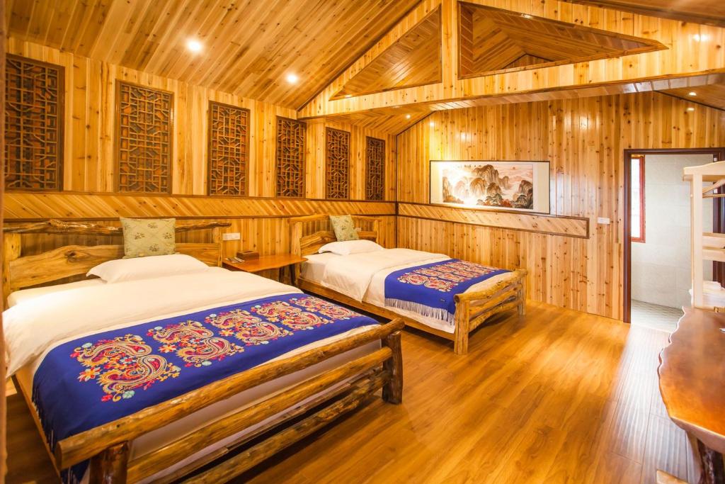 Postel nebo postele na pokoji v ubytování Long An Hotel 龙胜龙安酒店