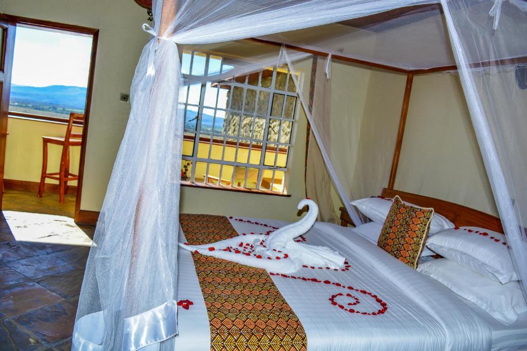 Postel nebo postele na pokoji v ubytování Mwanzo Lodge