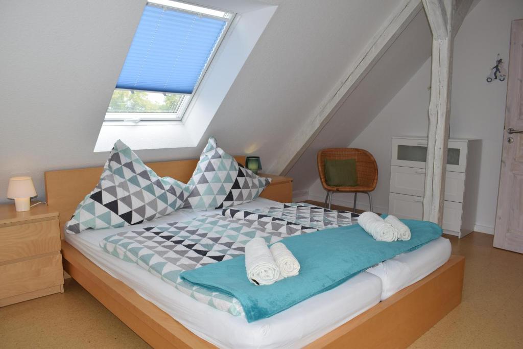 a bedroom with a bed with pillows and a window at Ferienwohnung Hafenwestseite Neustadt in Neustadt in Holstein