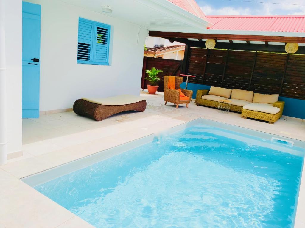 a swimming pool in the middle of a patio at Location Maison Bleue avec piscine privative au Carbet Martinique in Le Carbet