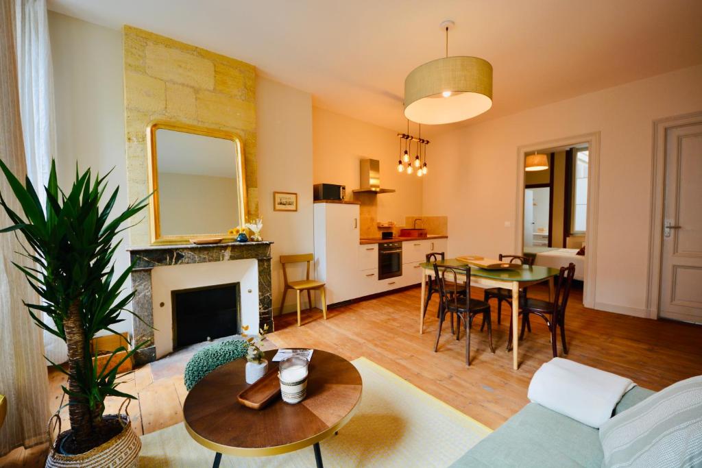 a living room with a couch and a table at Maison Bouquiere La Cabrerie in Bordeaux