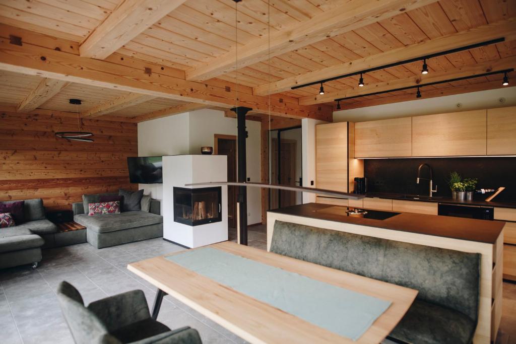 a living room with a table and a fireplace at Ferienhaus In den Bergen in Oberammergau