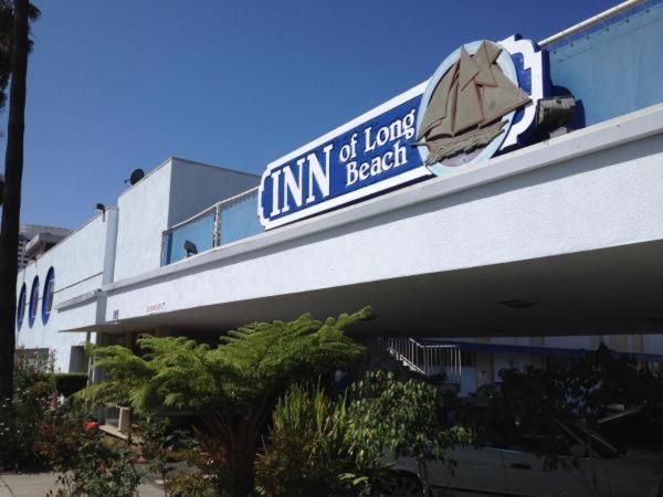 a building with a sign that readsimim beach at Inn Of Long Beach in Long Beach