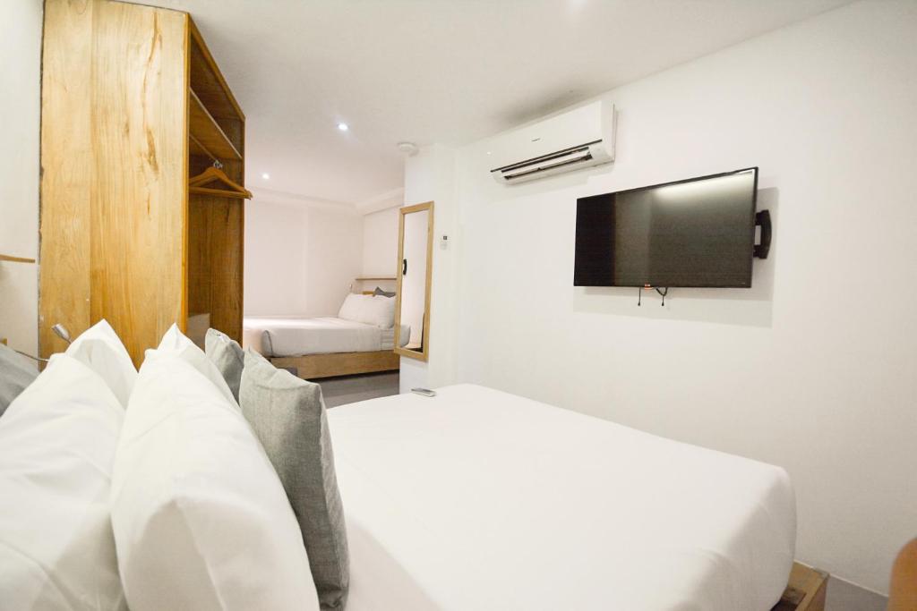 Postel nebo postele na pokoji v ubytování Zuzuni Boutique Hotel
