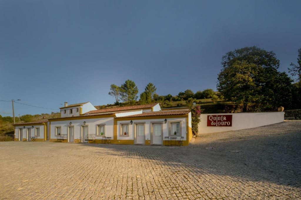 a building with a sign in front of it at Quinta do Louro in Palmela