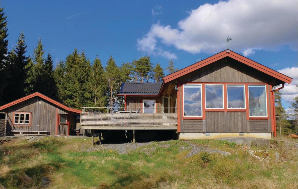 a house on a hill with trees in the background at 5 Bedroom Gorgeous Home In Tanumshede in Bullaren